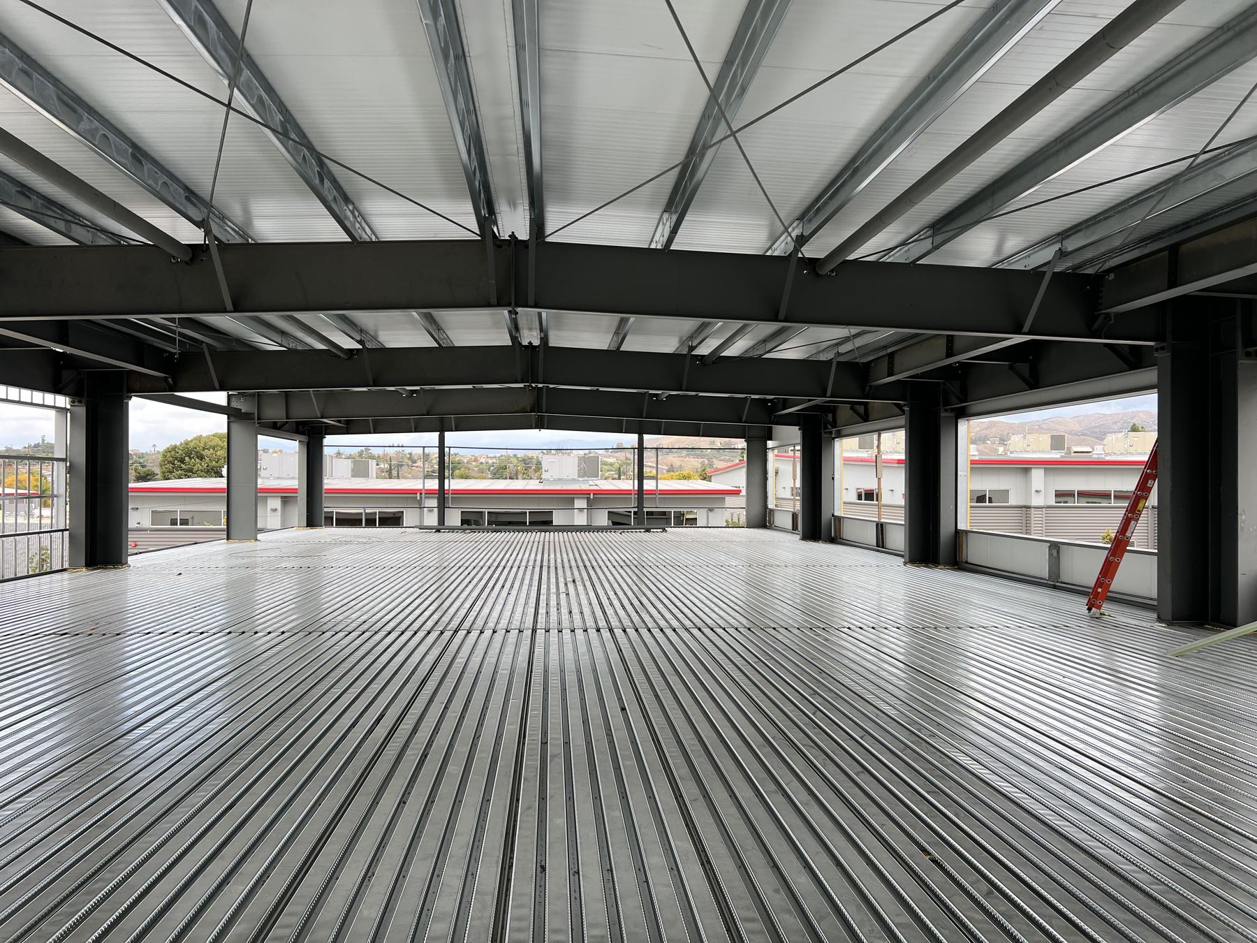 Interior view looking up at a two-story atrium with skylights